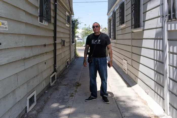 Mike is photographed in 2022 outside his childhood home near the corner of Pico Boulevard and Union in Los Angeles. Photos by David Reeve.